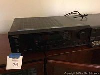 Onkyo TX-8255 stereo receiver and Technics 5-CD changer side by side on a wooden surface.