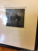 Framed print 'Tapestry' by M. Pascilicco, numbered 2/50, visible under glass with reflection of room.