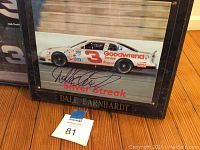 Close-up of the framed signed photograph of the #3 Goodwrench Silver Streak racing car by Dale Earnhardt