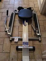 Full view of the Stamina 1215 Orbital Rower showing the seat, dual handlebars, and metal frame.
