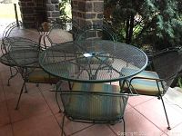 Full set on patio showing large table at center, side table and four chairs