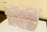 Front view of three owl figures showing carved details and overall form