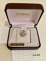 Front view of the emblem centered in the open O.C. Tanner presentation box with a label stating '10K GOLD EMBLEM'.