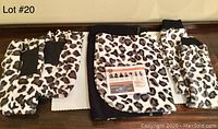 Lot showing leopard print gloves/mitts and tube socks laid out with instruction sheet visible.