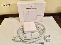 Apple 85W MagSafe Power Adapter with cable, plug, and original packaging box placed on white cloth.