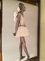 Front-facing photo of the print showing the ballerina sculpture in profile with a pale tutu and bow on the back.