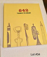 Front cover of the yellow sketchbook titled '642 Things to Draw' featuring simple art tools drawn in black lines.
