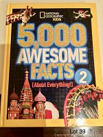 Front cover showing the title, images of a giraffe, Russian St. Basil's Cathedral, a pirate flag, and Ferris wheel.