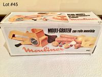 Box showing the Moulinex Mouli-Grater product with images and product name in several languages.