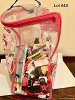 Front view of clear plastic bag containing mixed LEGO pieces inside.