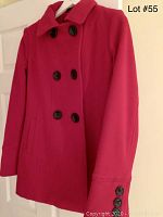 Front view of red wool coat on hanger showing double-breasted buttons and collar