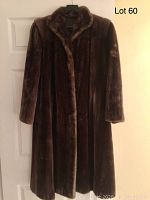 Front view of vintage brown fur coat showing the full length and collar detail.