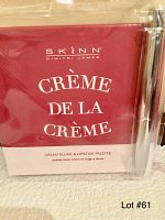 Photo showing the front of the SKINN Creme de la Creme cream blush and lipstick palette box with brush in packaging.