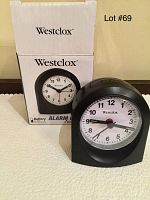 Black Westclox battery alarm clock alongside its original box showing front of clock and box with clock image and branding.