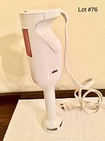 Full view of the white BRAUN handheld blender with power cord and plug, visible minor chip on the body side.