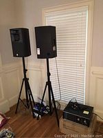 Two Martin Ranger Stage 5 speakers on SP-33 stands beside mixing amplifier