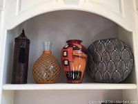 Four decorative vases and bottle holder displayed on shelf, showing size and details of each item.