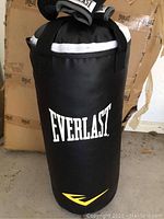 Front view of the Everlast heavy punching bag showing black vinyl material, white Everlast logo and yellow accent.