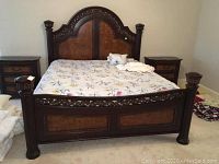 Full front view of ornate bed frame with bedding