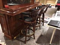 Three bar stools positioned at home bar counter