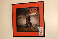 Front view of framed Blizzard of Ozz album cover with red mat and black frame
