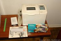 FoodSaver vacuum sealer with vacuum bags and accessories placed on a wooden table