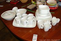 Photo of the full Corelle white porcelain dish set and Corningware Scandia white bowls, displayed on wooden table