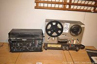 View of the T-Berd 209A T-Carrier Analyzer next to the Realistic TR 3000 Model 14 700 Reel to Reel Tape Recorder showing the front panels and details of both devices.