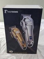 Front of box showing two Bestbomg wireless digital hair clippers in gold and silver with LED displays.