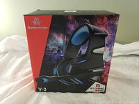 Front view of the Huntersprider V-3 Pro Gaming Headset box showing headset image with black and blue design and branding.