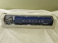 Side view of the boxed die cast truck showing full length and Winston branding on trailer.