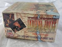 Closed, sealed box view showing Indiana Jones, other characters and map background with 36 packs label and Pro Set logo.