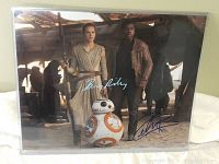 Close-up of signed 8x10 Star Wars photo showing Daisy Ridley, John Boyega, and BB-8 with signatures.