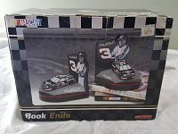 Box with clear display window showing the NASCAR Dale Earnhardt book ends inside, new in box.