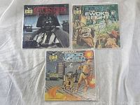 Three vintage Star Wars read-along record sets arranged on white fabric backdrop, front covers visible.