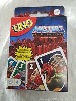 Front view of sealed Masters of the Universe UNO Card Game box by Mattel showing themed cards and special game rule.