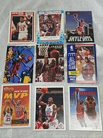 Photo showing 9 vintage basketball cards including Michael Jordan and Scottie Pippen cards, with colorful NBA All-Star and team themed cards