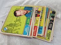 Stack of vintage 1967 Topps hockey cards with a visible card of Doug Harvey, defense, front side showing a lime green background with hockey silhouette graphics
