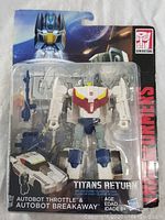 Front view of sealed Transformers Titans Return deluxe class Autobot Throttle and Autobot Breakaway figure in package. Shows figure, weapon accessory, package artwork and brand logos.