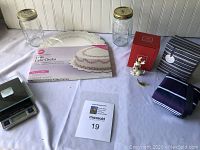 Full lot on table: 2 Ball mason jars, Wilton cake circles, insulated lunch tote, digital food scale, Lenox ornament.