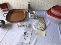 Full lot arrangement showing copper pan, mug, bread warmer, storage containers, pepper grinder, wine glass identifiers, and matches