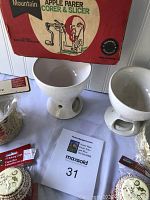 Vintage Mountain brand apple parer, corer & slicer with original box and two white ceramic heating dishes.