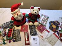 Full display of holiday plush items, lights, gift bags, ribbons, tags and small decorations