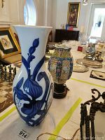 Overview of lot showing Italian ceramic vase in front and painted ceramic lamp base behind