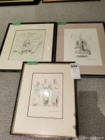 Three framed black and white sketches by Sol Schweitzer displayed on floor, showing overall lot condition and layout.