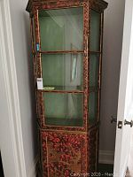 Front view of closed cabinet showing upper glass display and lower painted door
