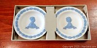 Two Wedgwood Royal Wedding plates in original box, cream-colored with blue relief profiles and leafy border.