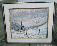 Full view of the framed acrylic painting featuring a snowy winter landscape with a lone skier and trees.