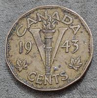 Reverse side of the 1943 Canadian 5-cent tombac nickel coin showing a large V with torch, date, two maple leaves, 'CANADA' and 'CENTS' inscriptions.