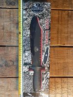 Front packaging of Mossy Oak War Horse knife box showing image of the knife with black serrated blade and handle. Includes Mossy Oak branding.